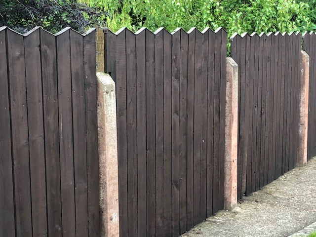 Garden fence painted with Creocote wood treatment