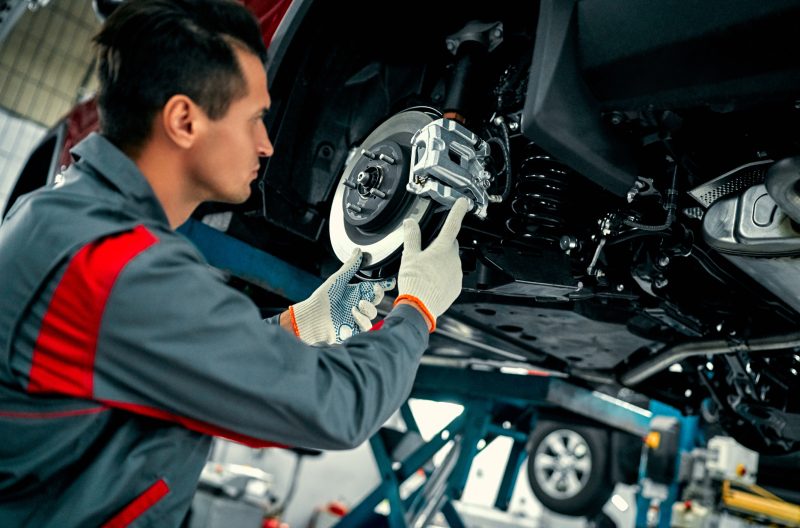 Mechanic servicing brakes