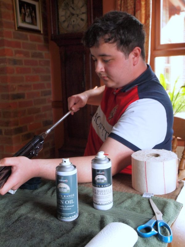 William Gilbert cleaning his gun