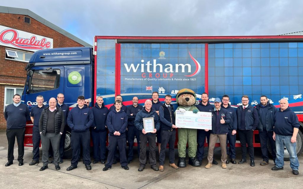 Witham Team members at the Lincoln Factory presenting the Help for Heroes charity ‘Hero Bear’ mascot with a fundraising cheque for £2,000.