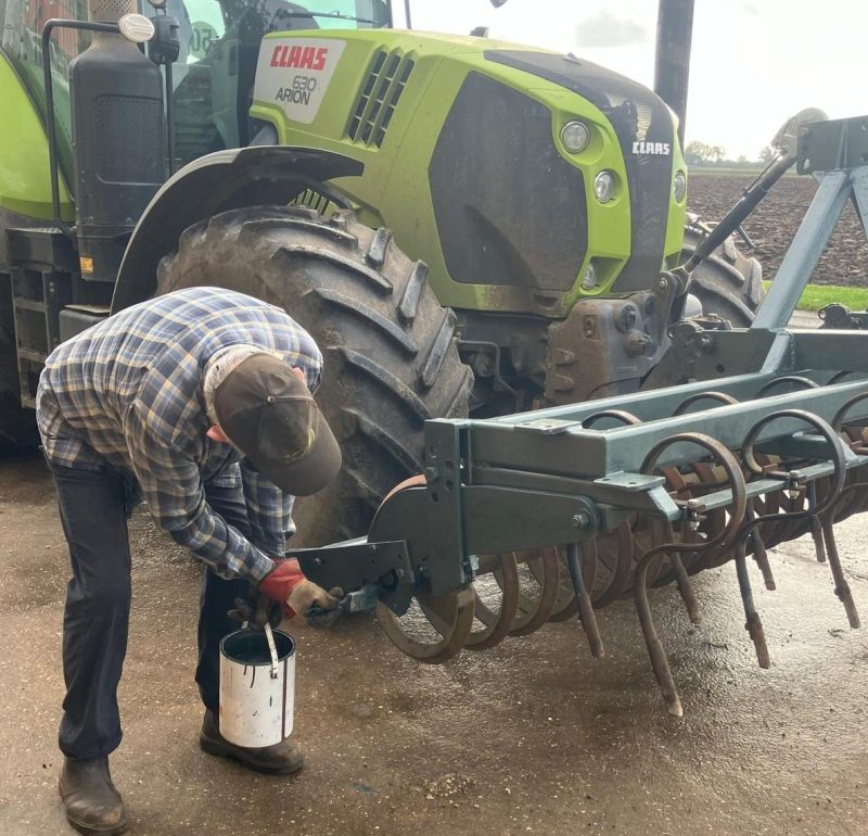 Woco Paint being applied to farm equipment